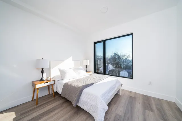 a bedroom with a bed and a window