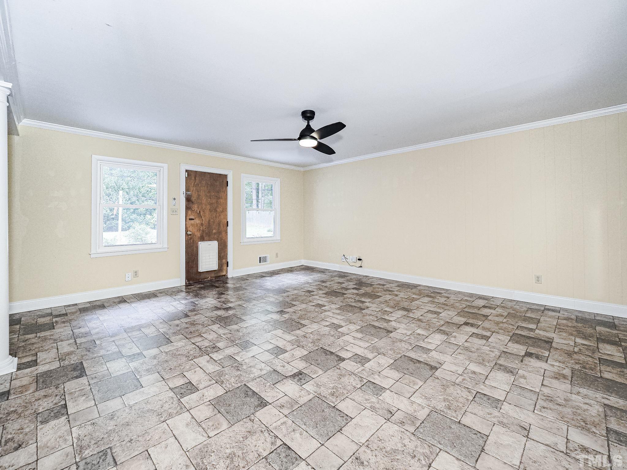 1314 Trinity Circle Raleigh, NC 27607 - Photo 13 of 33 an empty room with windows and ceiling fan