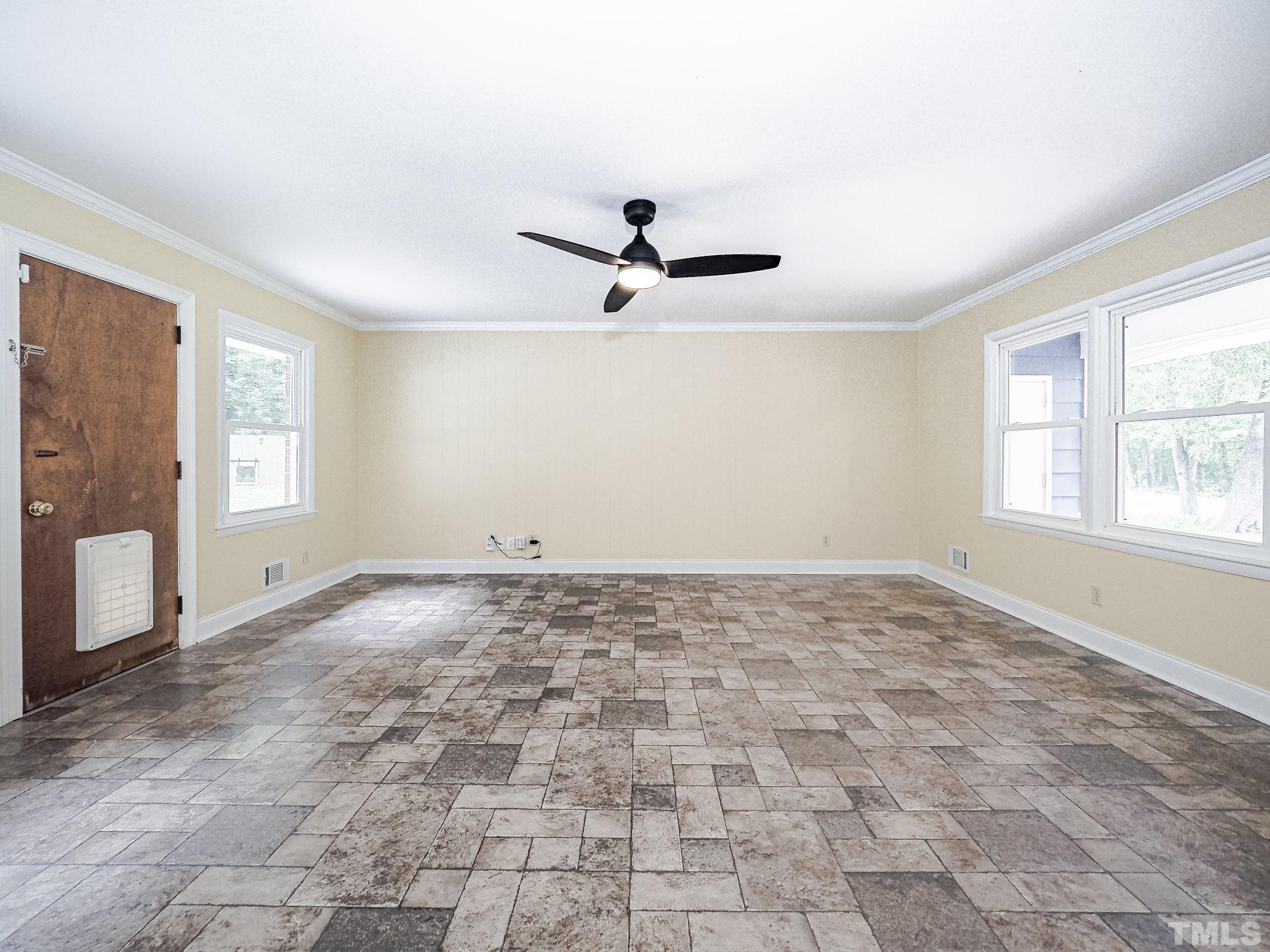 1314 Trinity Circle Raleigh, NC 27607 - Photo 14 of 33 an empty room with windows and ceiling fan