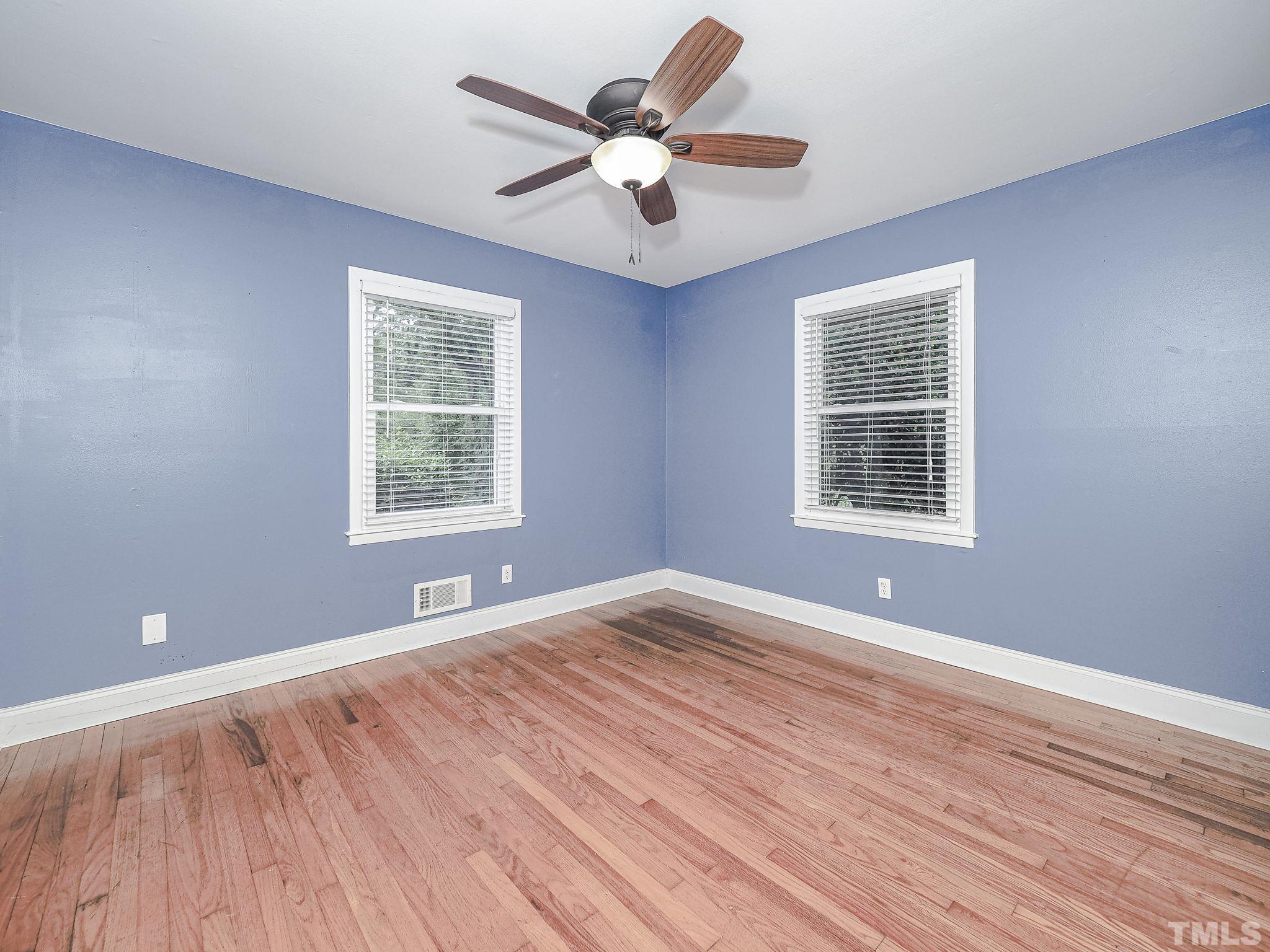 1314 Trinity Circle Raleigh, NC 27607 - Photo 16 of 33 a view of an empty room with wooden floor and a window