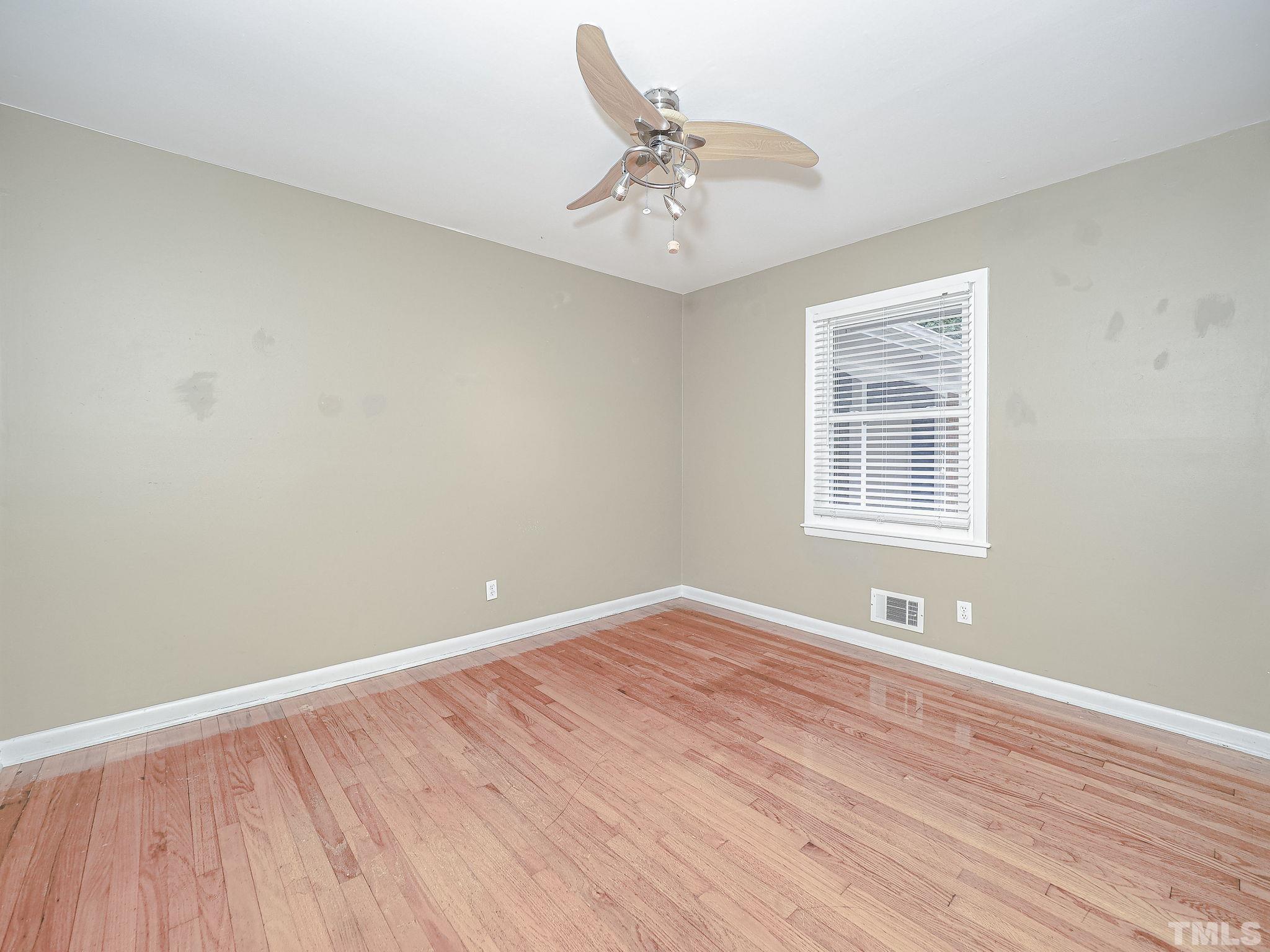 1314 Trinity Circle Raleigh, NC 27607 - Photo 18 of 33 wooden floor in an empty room with a window