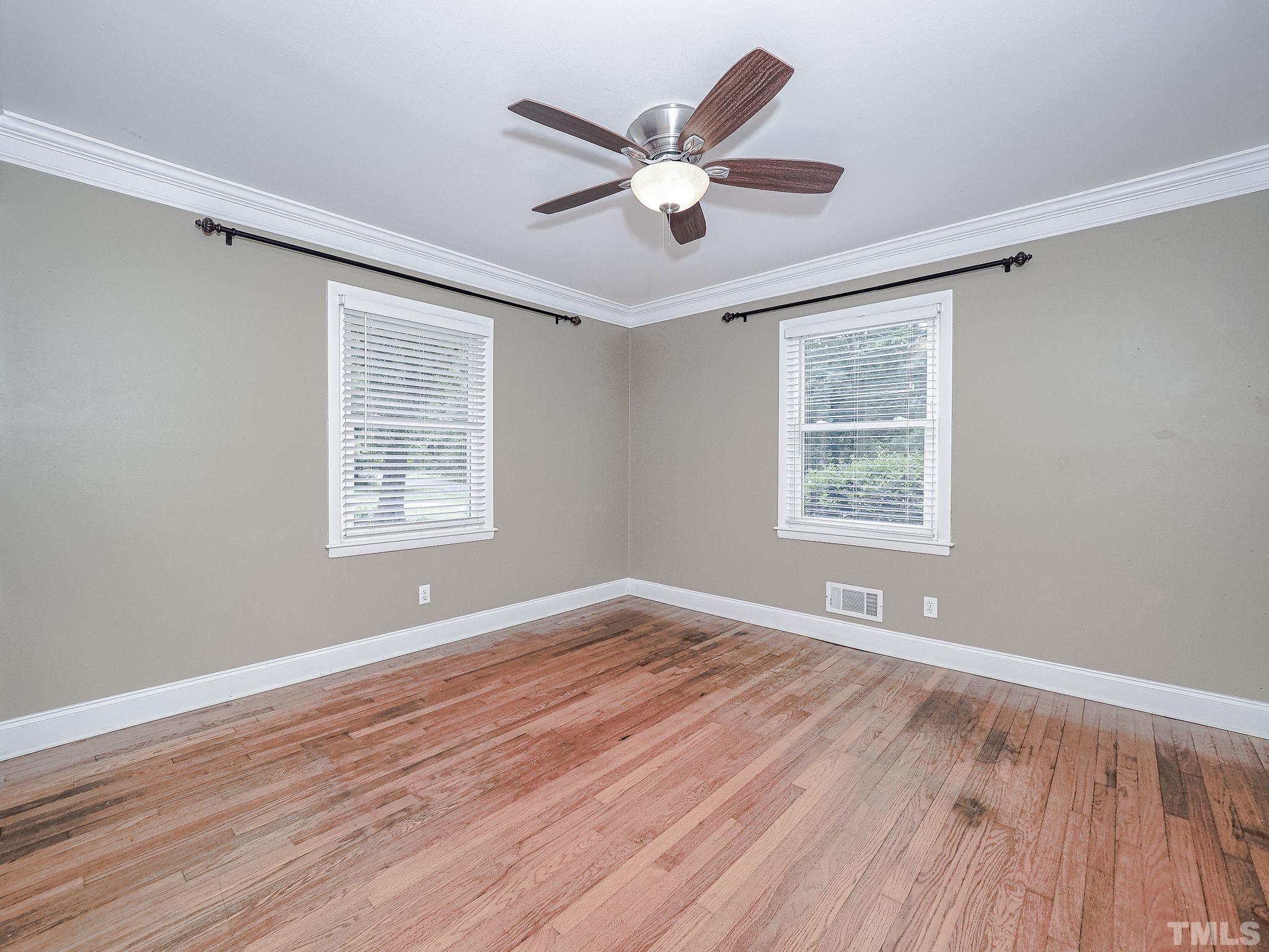 1314 Trinity Circle Raleigh, NC 27607 - Photo 29 of 33 a view of an empty room with wooden floor and a window