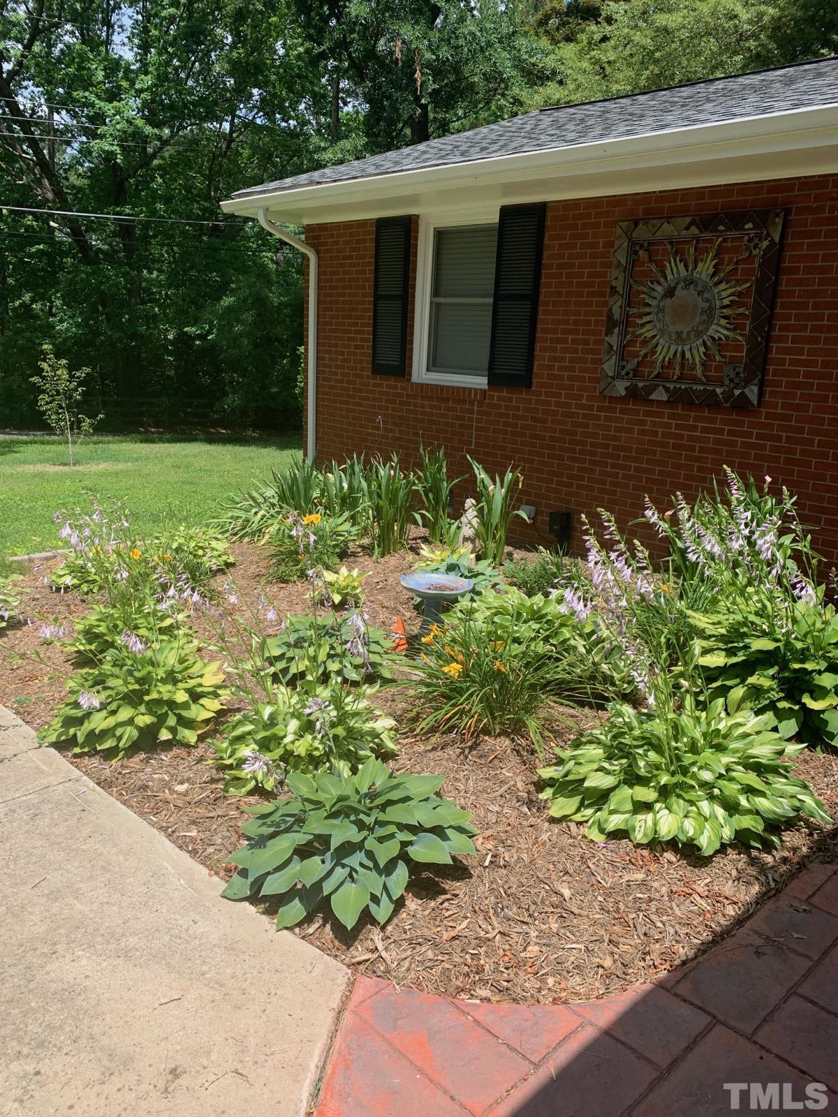 1314 Trinity Circle Raleigh, NC 27607 - Photo 32 of 33 a front view of a house with garden
