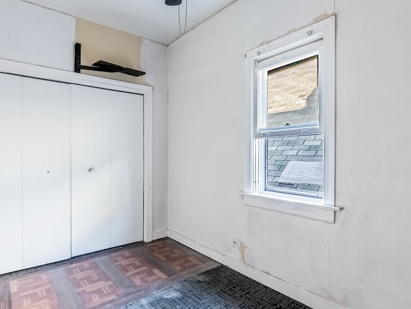 3244 North Drake Avenue Chicago, IL 60618 - Photo 11 of 37 a view of an empty room with wooden floor and a window