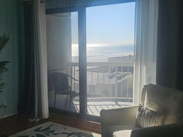 a living room with furniture and a floor to ceiling window