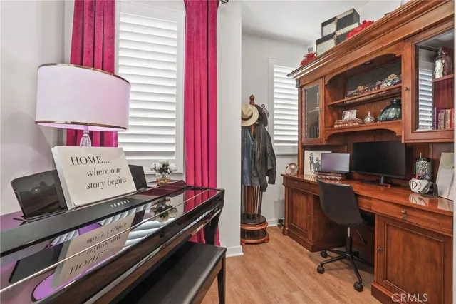 a view of a workspace with furniture and a window