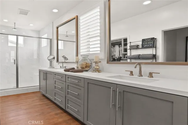 a bathroom with double sink and a mirror