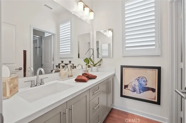 a bathroom with a double vanity sink and a mirror