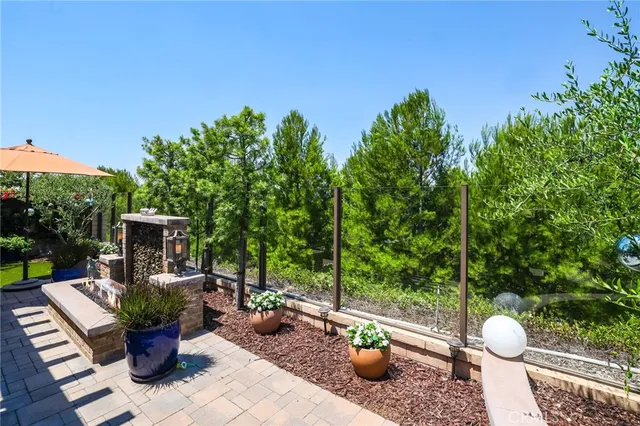 a view of a porch with furniture and a garden