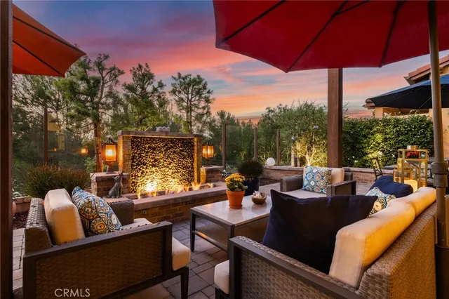 a outdoor living room with patio furniture and a potted plant