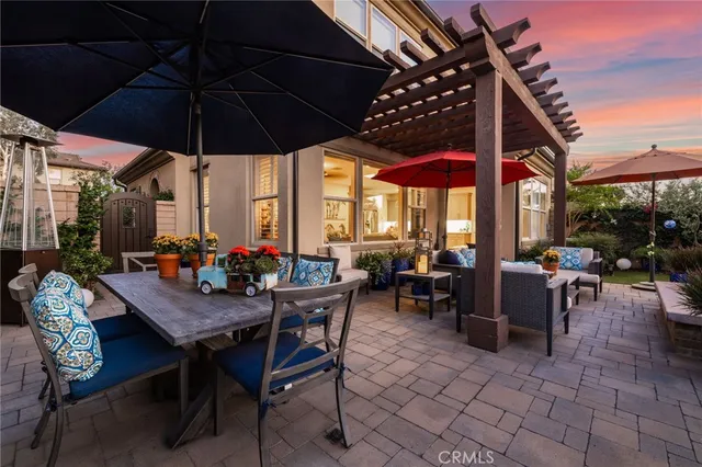 a view of a patio with a table and chairs under an umbrella