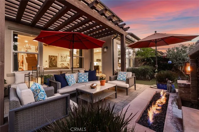 a outdoor living space with furniture and umbrella