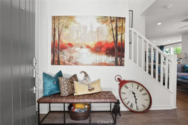 a view of a hallway with entryway wooden floor and front door