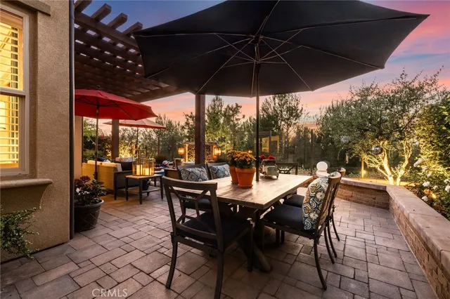 a view of a patio with table and chairs under an umbrella