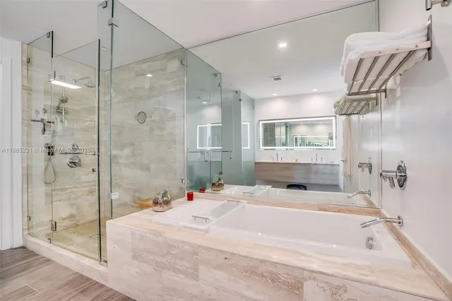 a bathroom with a bathtub and a shower