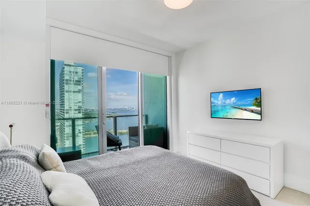 a bedroom with a bed and a painting on the wall