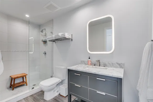 a bathroom with a toilet sink and mirror