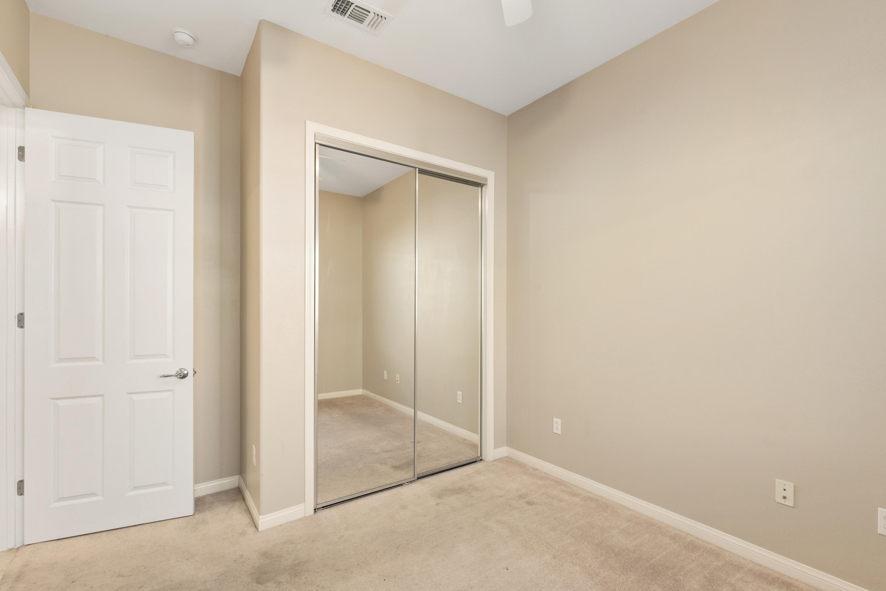 81935 Avenida Bienvenida Indio, CA 92203 - Photo 11 of 35 an empty room with mirror in closet