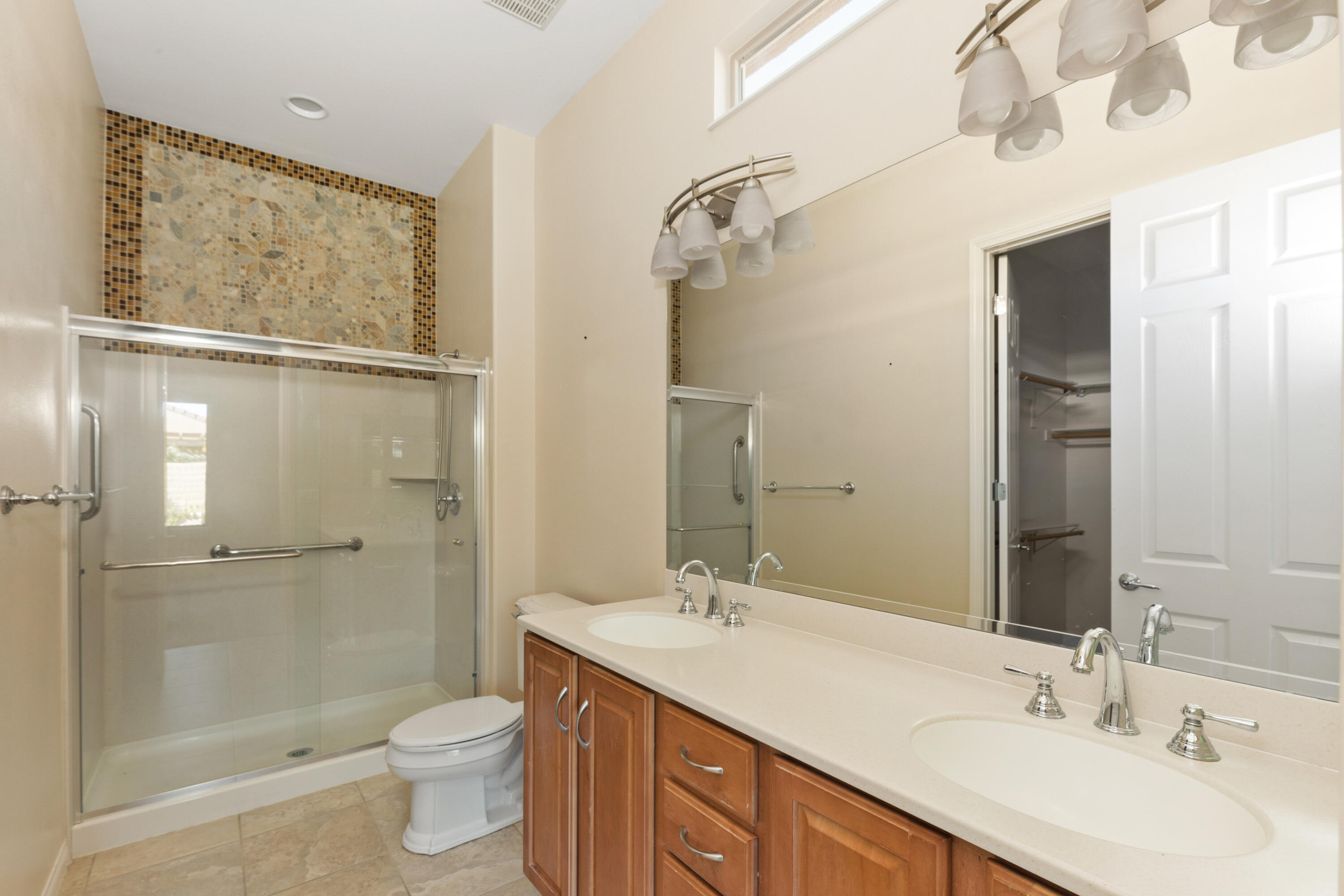 81935 Avenida Bienvenida Indio, CA 92203 - Photo 14 of 35 a bathroom with a sink toilet double vanity and shower