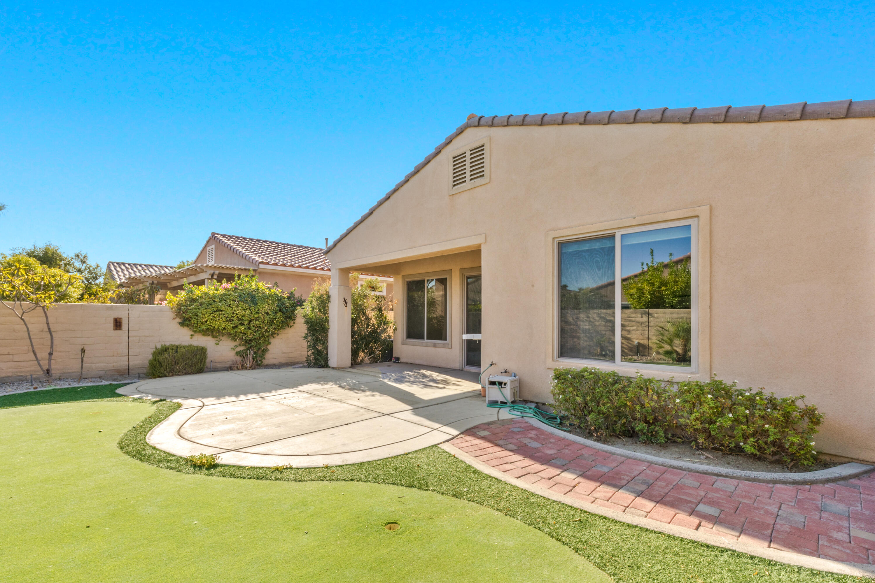 81935 Avenida Bienvenida Indio, CA 92203 - Photo 20 of 35 a view of a house with a swimming pool and yard