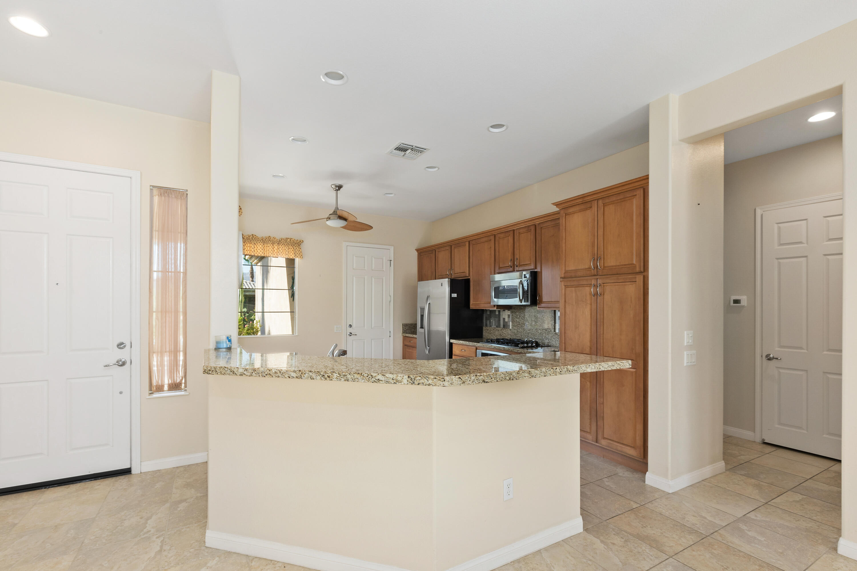 81935 Avenida Bienvenida Indio, CA 92203 - Photo 6 of 35 a view of kitchen with kitchen island a sink stainless steel appliances and cabinets