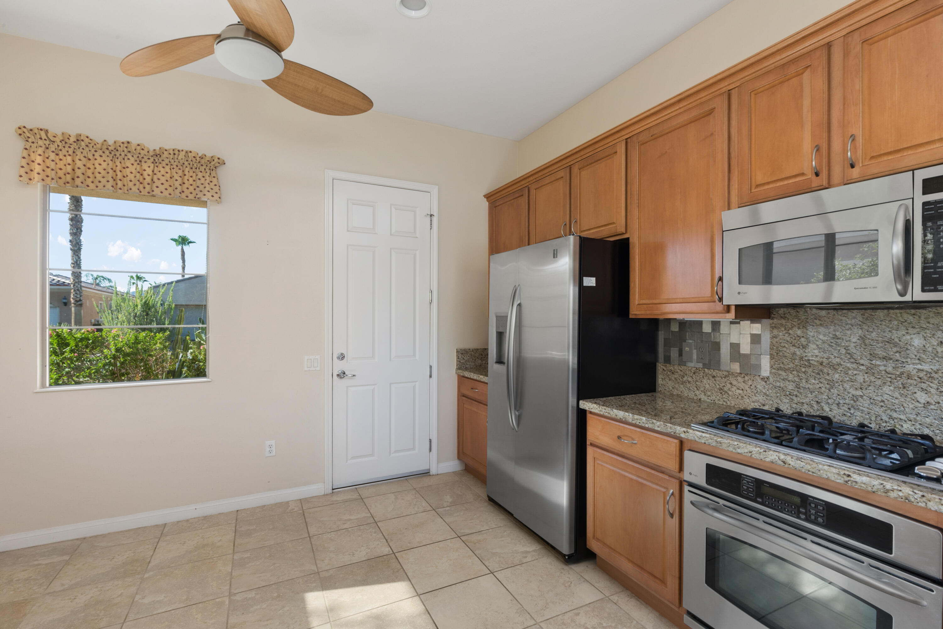 81935 Avenida Bienvenida Indio, CA 92203 - Photo 8 of 35 a kitchen with stainless steel appliances granite countertop a refrigerator a stove a microwave and cabinets