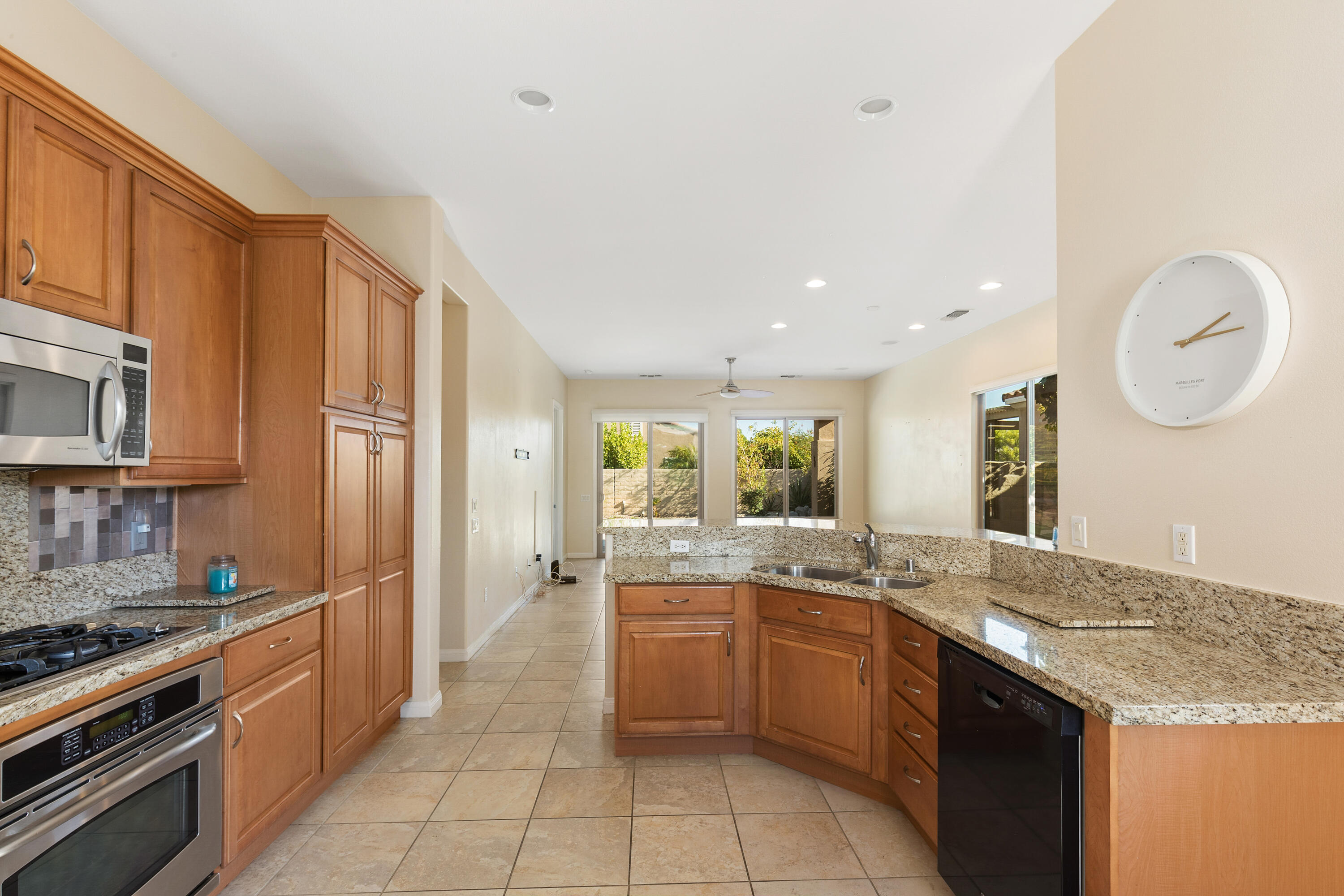 81935 Avenida Bienvenida Indio, CA 92203 - Photo 10 of 35 a large kitchen with granite countertop a sink stainless steel appliances and cabinets
