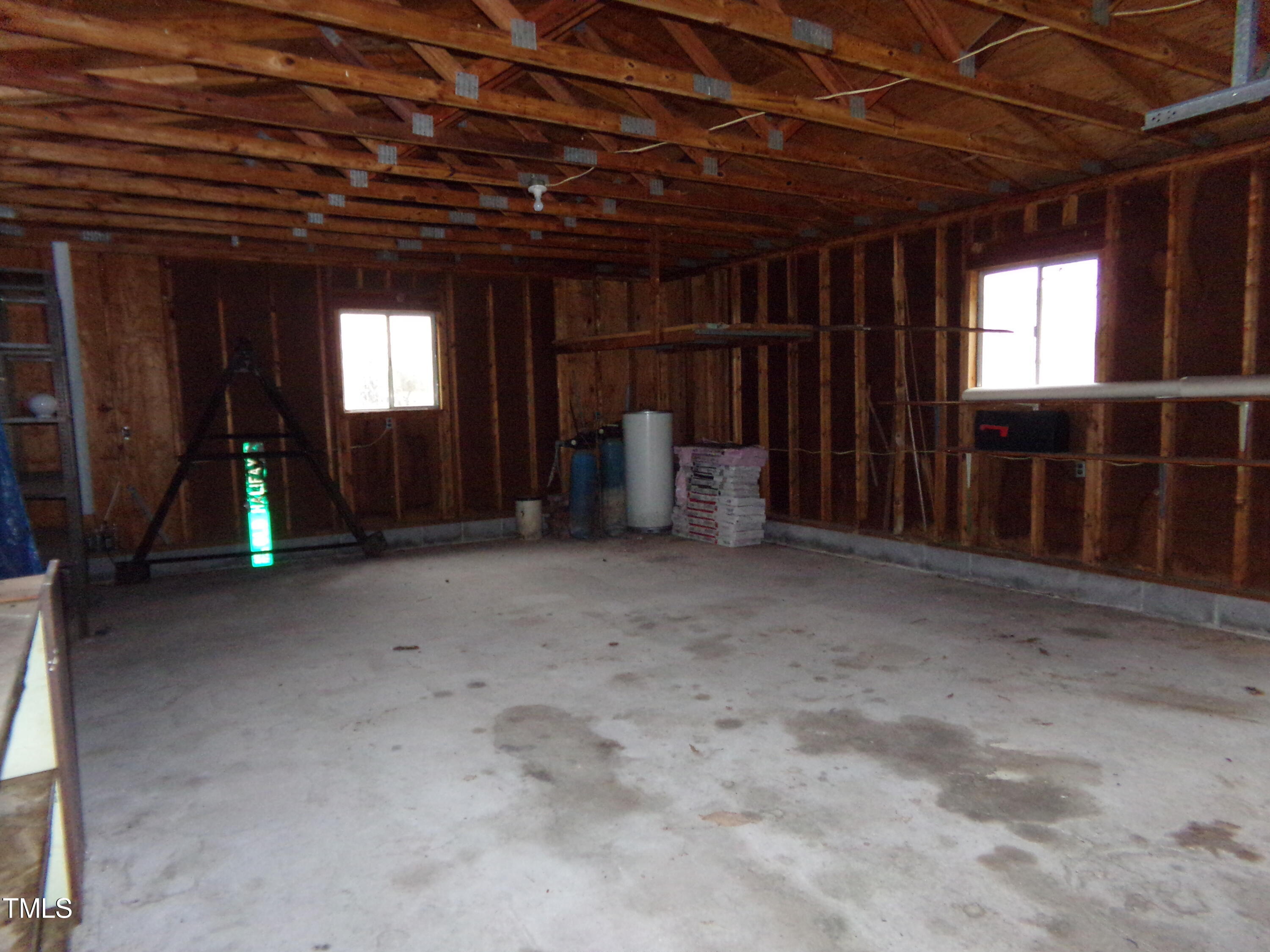 2871 Pilot-Riley Road Zebulon, NC 27597 - Photo 25 of 32 a view of an empty room with wooden floor and a window