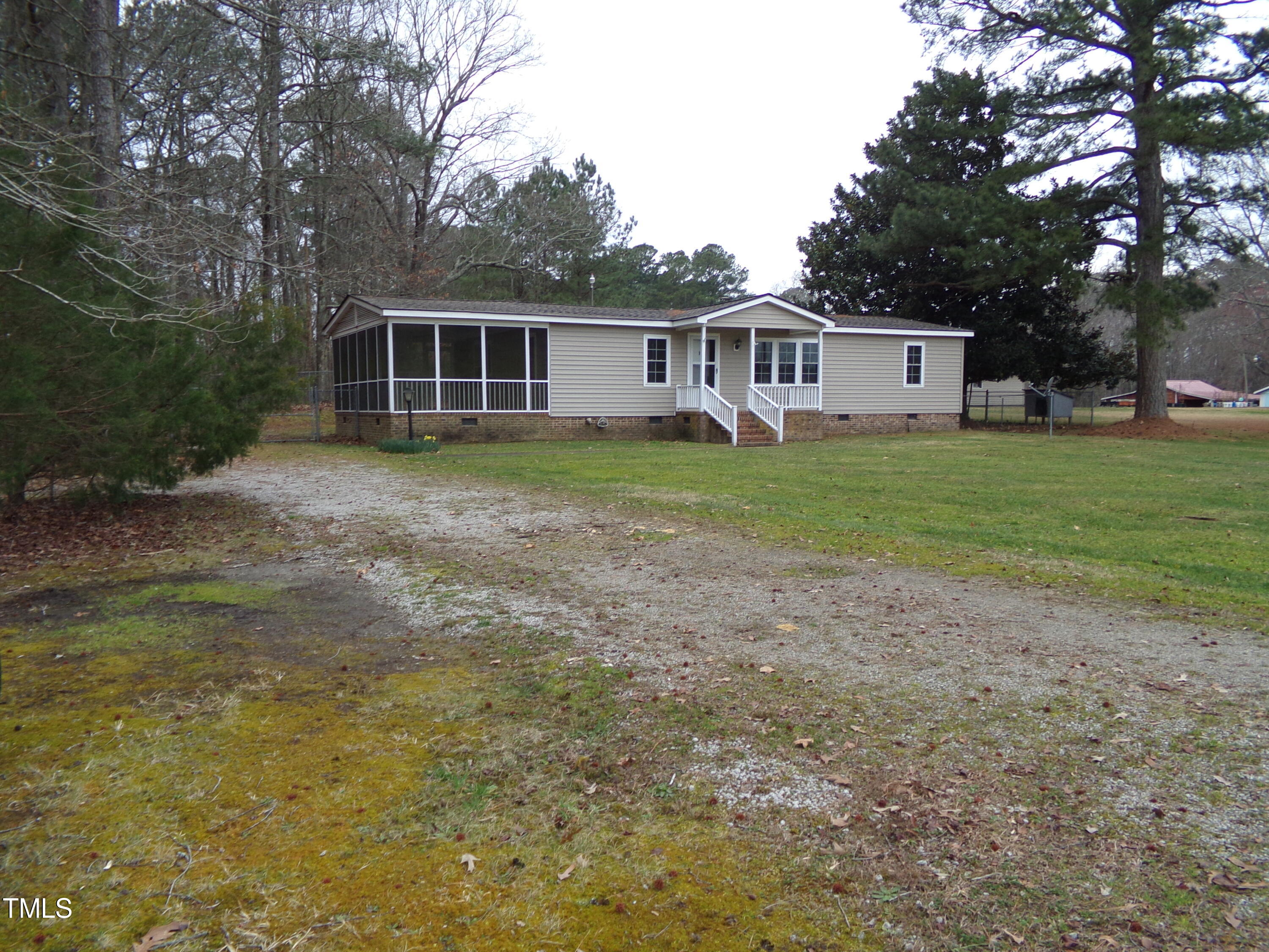2871 Pilot-Riley Road Zebulon, NC 27597 - Photo 5 of 32 a front view of a house with a garden