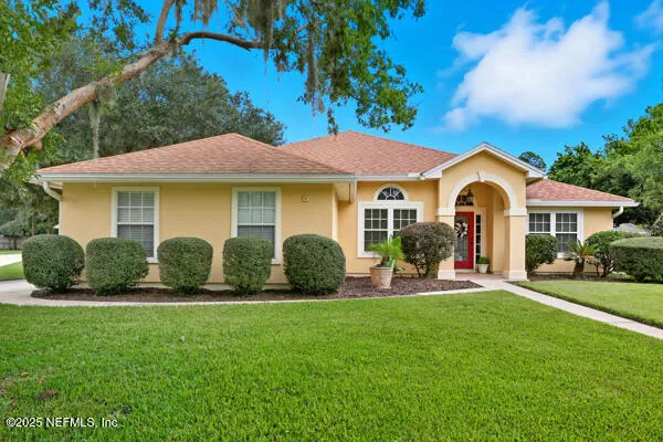 a front view of a house with a garden and porch