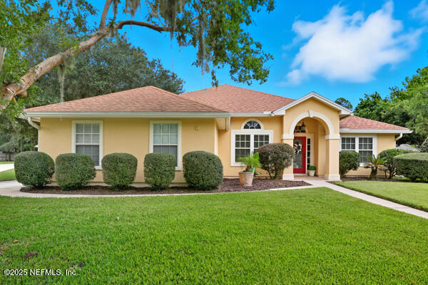 a front view of a house with a garden and porch