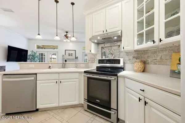 a kitchen with stainless steel appliances white cabinets and a stove