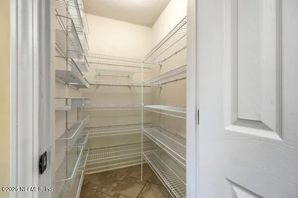 a bathroom with a walk in closet and a window