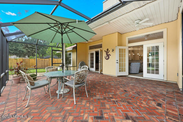 11381 Mandarin Ridge Lane Jacksonville, FL 32258 - Photo 34 of 43 a patio with a patio table and chairs