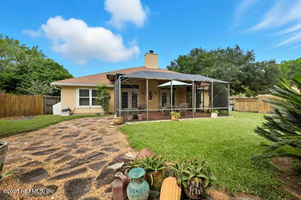 a view of a house with backyard porch and garden