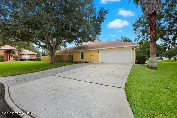 a view of backyard of house with green space