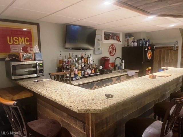 178 Patterson Road Weirton, WV 26062 - Photo 30 of 50 Bar featuring a paneled ceiling, black fridge, and sink