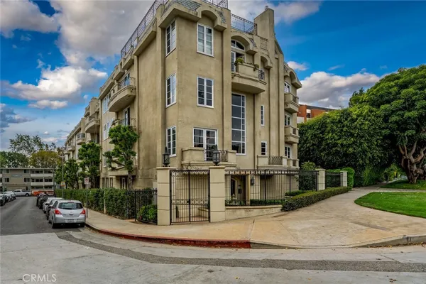 a view of a building with car parked