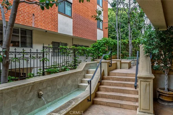 a view of balcony with two chairs and a small yard