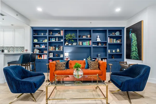 a living room with furniture and a book shelf