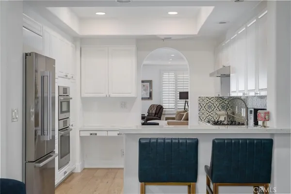 a kitchen with stainless steel appliances granite countertop a refrigerator sink and cabinets