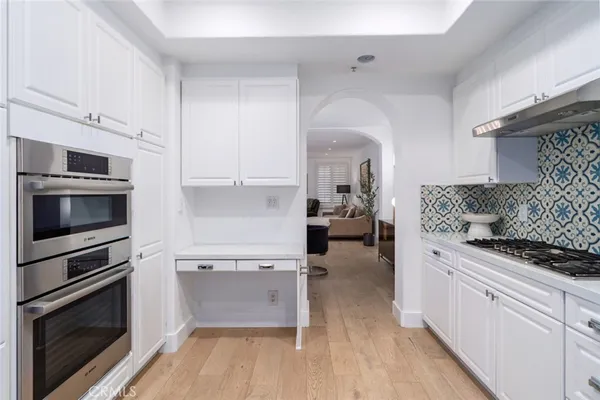 a kitchen with stainless steel appliances a stove microwave and cabinets