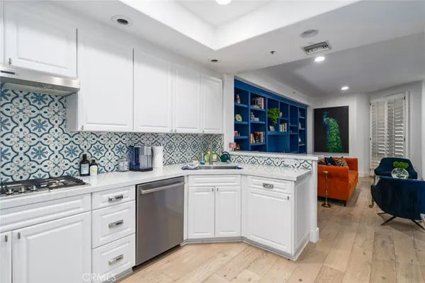 a kitchen with white cabinets and white appliances