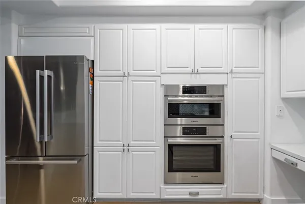 a kitchen with cabinets and stainless steel appliances