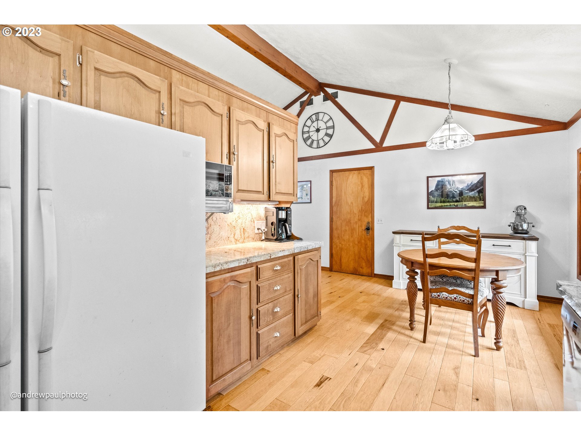 17835 Frost Road Dallas, OR 97338 - Photo 8 of 40 a open kitchen with stainless steel appliances granite countertop a refrigerator a stove a sink dishwasher and white cabinets with wooden floor