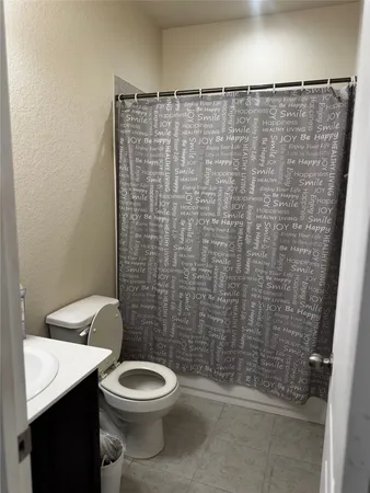 a bathroom with a sink vanity and toilet