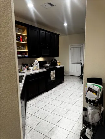 a kitchen with a sink and a refrigerator