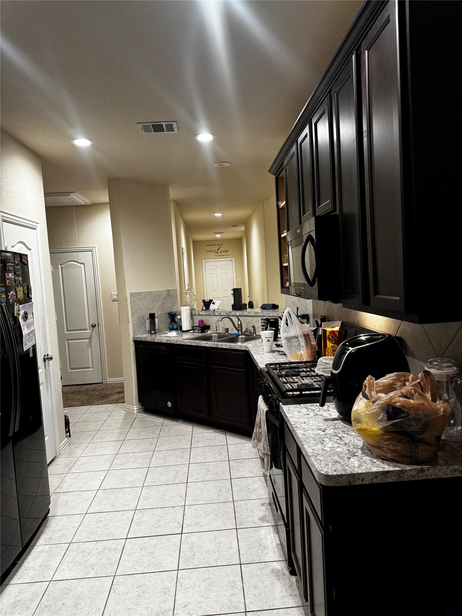22739 Highland Maple Court Spring, TX 77373 - Photo 29 of 48 a kitchen with a sink and a refrigerator