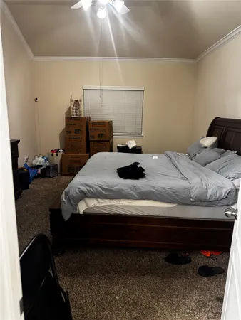 a bed sitting in a bedroom and chair