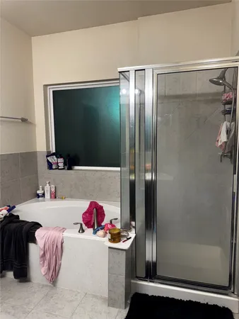 a bathroom with a tub and a shower